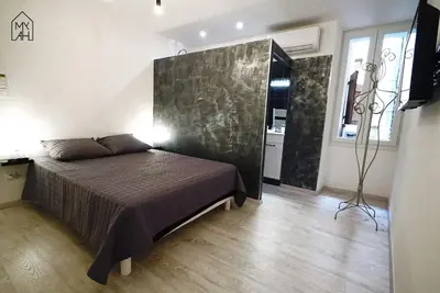 a bedroom with a large bed in a room at Carlota - Appartement rénové au cœur de la vieille ville - by TGB in Ajaccio