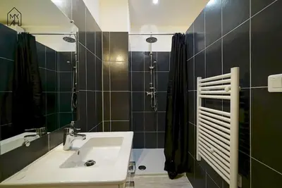 a bathroom with a sink and a shower at Carlota - Appartement rénové au cœur de la vieille ville - by TGB in Ajaccio