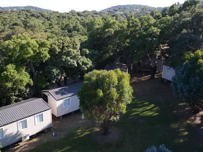 an overhead view of two mobile homes in the woods at La Vetta Village Vacances Camping in Porto-Vecchio