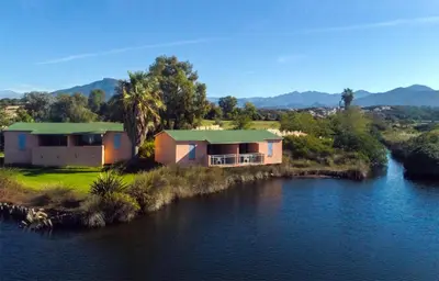 a house sitting on the side of a river at Résidence Marina di Capitello in Porticcio