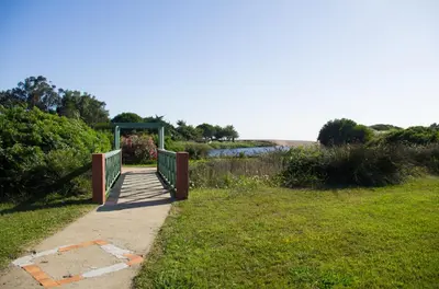 a walkway leading into a park with a field at Résidence Marina di Capitello in Porticcio