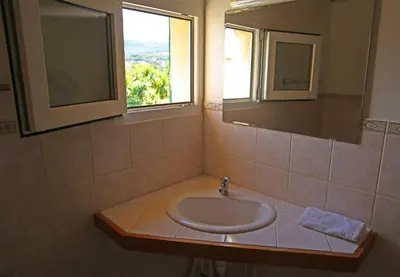 a bathroom with a sink and a window at Résidence Marina di Capitello in Porticcio