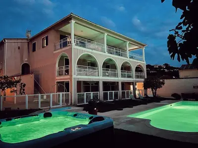 a large house with a swimming pool in front of it at Résidence Villa Romana avec Piscine et Jacuzzi in Propriano