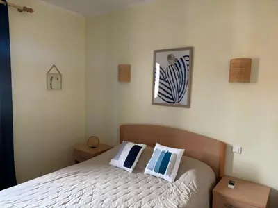 a bedroom with a bed with two pillows on it at Résidence Villa Romana avec Piscine et Jacuzzi in Propriano