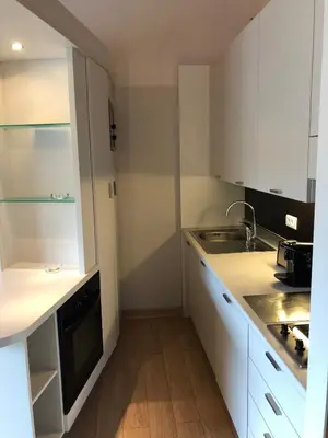 a small kitchen with a sink and a stove at Résidence Cala Sultana Appartement T2 in Porto-Vecchio