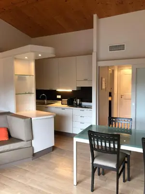 a kitchen and dining room with a table and chairs at Résidence Cala Sultana Appartement T2 in Porto-Vecchio