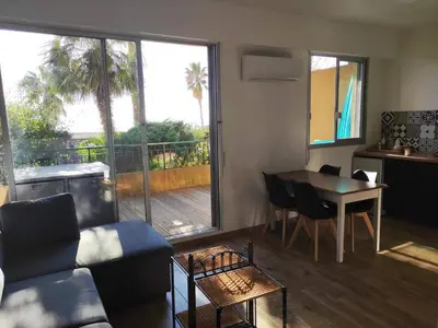 a living room with a couch and a table at Superbe T1 neuf avec vue mer sur Marinella in Ajaccio