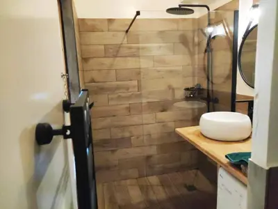 a bathroom with a sink and a shower with a toilet at Superbe T1 neuf avec vue mer sur Marinella in Ajaccio