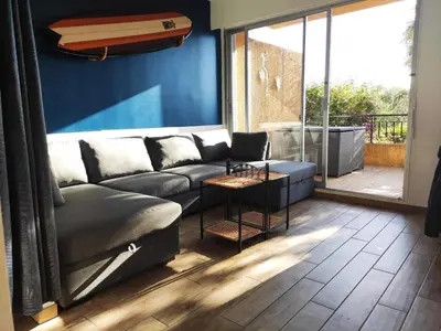 a living room with a couch and a large window at Superbe T1 neuf avec vue mer sur Marinella in Ajaccio