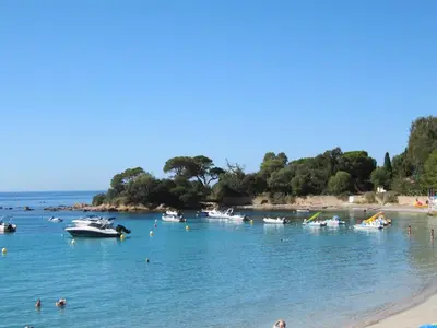 a group of people in the water at a beach at Superbe T1 neuf avec vue mer sur Marinella in Ajaccio