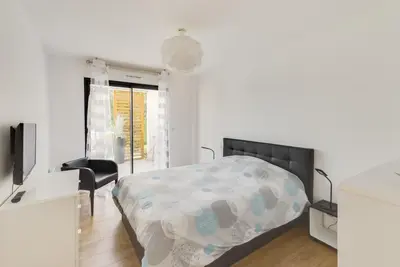 a bedroom with a bed and a desk and a television at L'Ebene in Coti-Chiavari