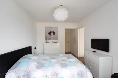 a bedroom with a bed and a flat screen tv at L'Ebene in Coti-Chiavari