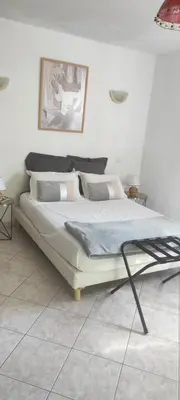 a bed in a white room with at Belle maison de charme ancien, vue mer et montagne in Casalabriva