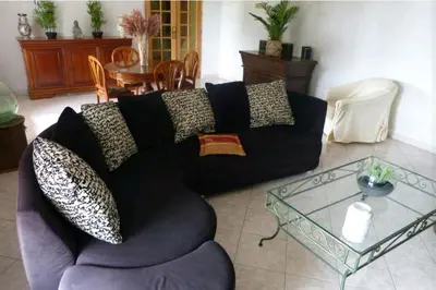 a living room with a couch and a glass table at Belle maison de charme ancien, vue mer et montagne in Casalabriva