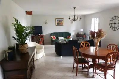 a living room with a table and a couch at Belle maison de charme ancien, vue mer et montagne in Casalabriva