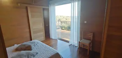 a bedroom with a bed and a large window at VILLA ANGELINI in Valle-di-Campoloro