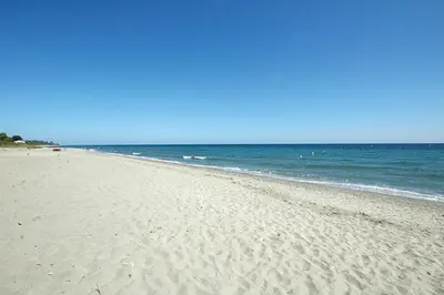a sandy beach with the ocean in the background at VILLA ANGELINI in Valle-di-Campoloro
