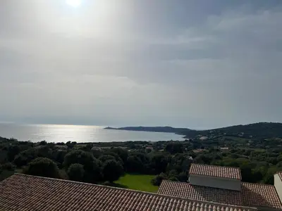 a view of the water from the roof of a house at Résidence Castugna in Cargèse