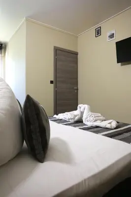 a bedroom with two beds with towels on them at Le Banana's Hotel in Aléria