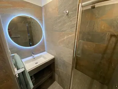 a shower with a glass door in a bathroom at Villas Valinco San Martinu Corse du Sud - vue et proche mer - piscines-7 chambres in Olmeto