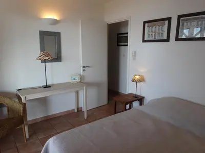 a bedroom with a bed and a desk and a lamp at Villas Valinco Capicciolo vue-proche mer-piscines in Olmeto