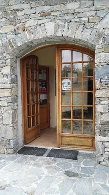 an entrance to a stone building with a wooden door at L'Albadu in Corte