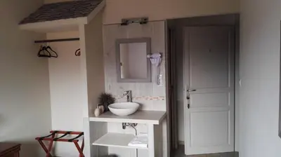a bathroom with a sink and a mirror at L'Albadu in Corte
