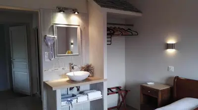 a bathroom with a sink and a mirror at L'Albadu in Corte