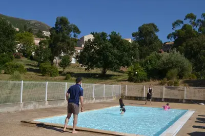 a group of people playing in a swimming pool at Hôtel 