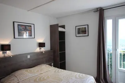 a bedroom with a bed and a window at Hôtel 