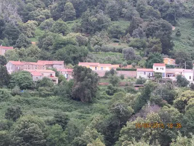 a group of houses on the side of a mountain at Peri village in Peri