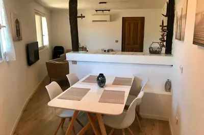 a table and chairs in a room with a kitchen at Villa Solsticia in Porticcio