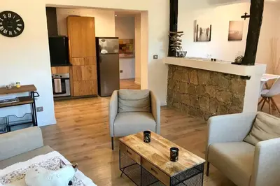 a living room with a couch and chairs and a table at Villa Solsticia in Porticcio