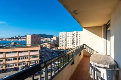 a balcony of a building with a view of a city at Bel Orizonte, Grand appart 70m2 vue mer in Ajaccio