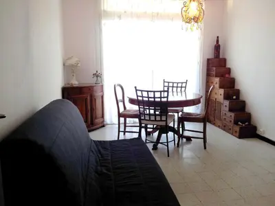a living room with a table and chairs and a window at Bel Orizonte, Grand appart 70m2 vue mer in Ajaccio