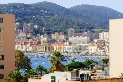 a view of a city with boats in a harbor at Bel Orizonte, Grand appart 70m2 vue mer in Ajaccio