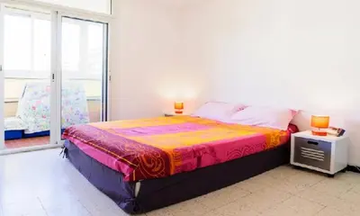 a bedroom with a large bed and a window at Bel Orizonte, Grand appart 70m2 vue mer in Ajaccio