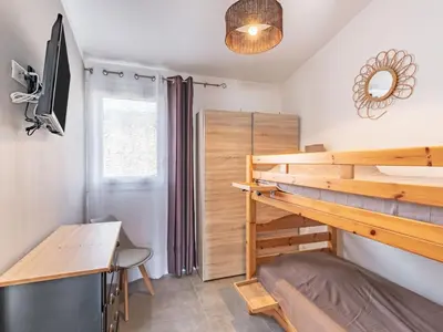a bedroom with a bunk bed and a desk at Holiday Home Mustella by Interhome in Sari Solenzara