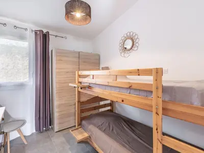 a bedroom with a bunk bed and a window at Holiday Home Mustella by Interhome in Sari Solenzara