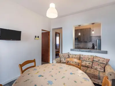 a living room with a couch and a table at Holiday Home Scorpina by Interhome in Sari Solenzara