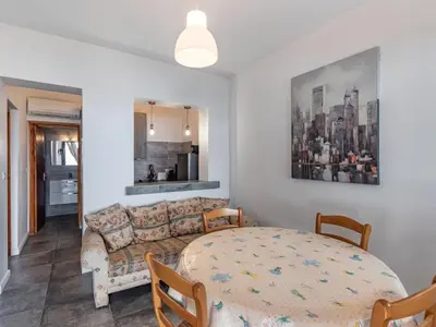 a living room with a table and a couch at Holiday Home Scorpina by Interhome in Sari Solenzara
