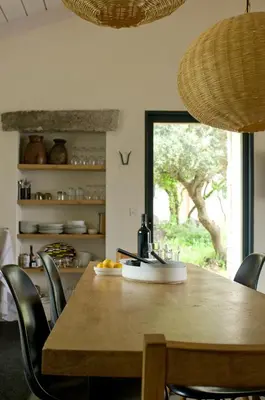 a dining room with a table and chairs and a window at Domaine de Peretti della Rocca in Figari