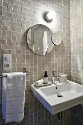 a bathroom with a sink and a mirror and towels at Domaine de Peretti della Rocca in Figari