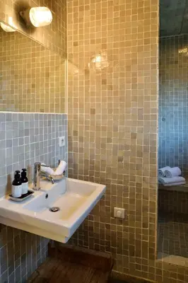 a bathroom with a sink and a mirror at Domaine de Peretti della Rocca in Figari