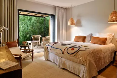 a bedroom with a bed and a large window at Domaine de Peretti della Rocca in Figari