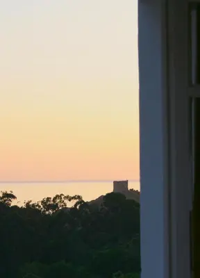 a view of a castle on top of a hill at Hôtel Colombo- Porto Corse in Porto Ota