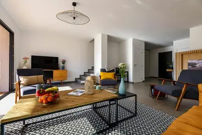 a living room with a table with a bowl of fruit on it at Calarossa Bay Resort in Porto-Vecchio