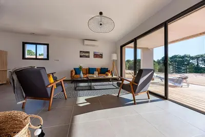 a living room with chairs and a table at Calarossa Bay Resort in Porto-Vecchio