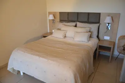 a bedroom with a large bed in a room at Résidence Giovanello in Porto Pollo