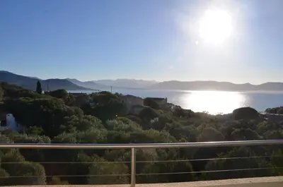 a view of the water with the sun in the sky at Résidence Giovanello in Porto Pollo